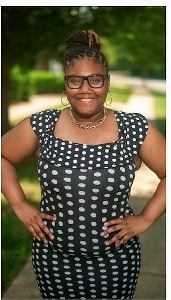 Melody Carey, the owner and caregiver at Melody's Angels, standing outdoors on a tree-lined path in Charlotte, North Carolina.
